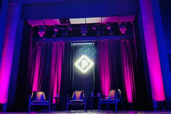 Stage at paradise Cinema with three seats for the panel